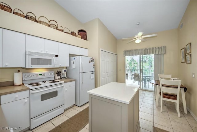 kitchen with light tile patterned floors, light countertops, white cabinets, ceiling fan, and white appliances