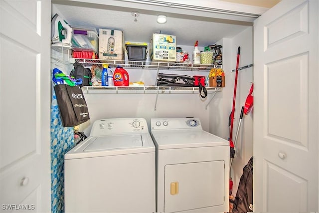 clothes washing area featuring laundry area and washing machine and clothes dryer