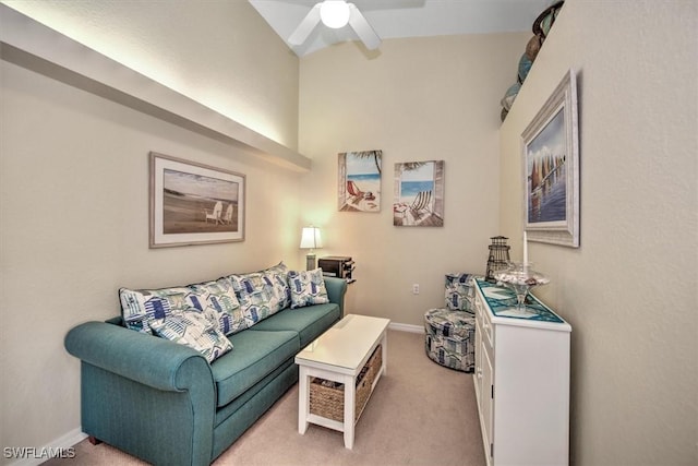 living room with baseboards, a ceiling fan, and light colored carpet