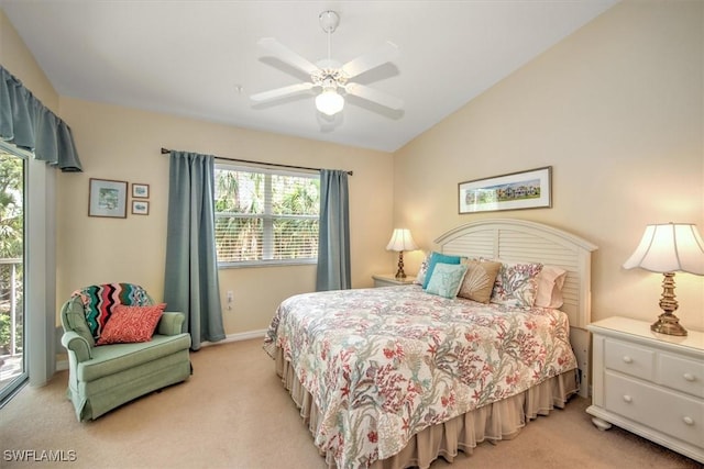 bedroom featuring lofted ceiling, light carpet, and ceiling fan