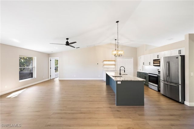 kitchen with ceiling fan with notable chandelier, a sink, white cabinetry, light wood-style floors, and appliances with stainless steel finishes