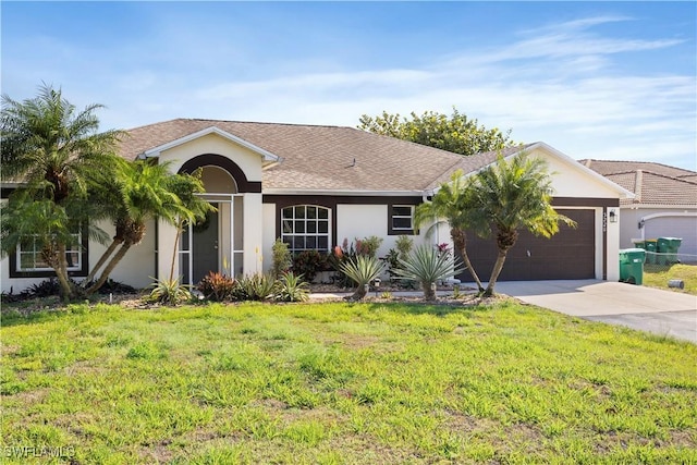 single story home with a garage, a front yard, concrete driveway, and stucco siding