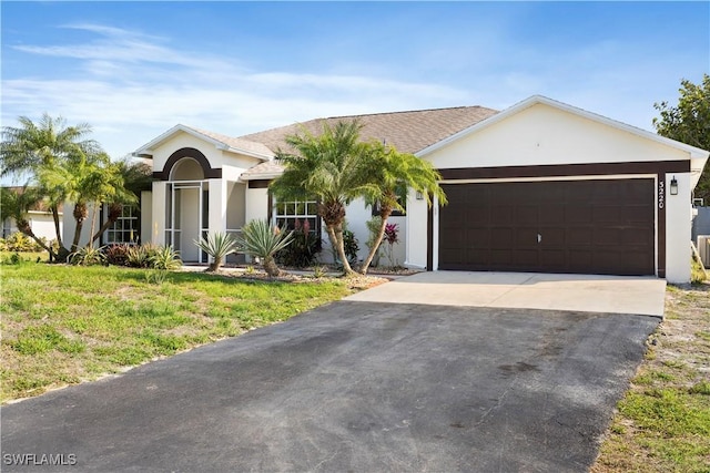 view of front of home with an attached garage, driveway, and stucco siding