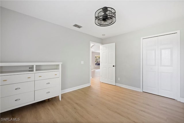 unfurnished bedroom with baseboards, visible vents, and light wood finished floors