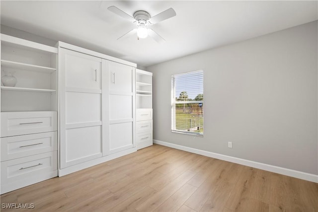 unfurnished bedroom featuring ceiling fan, light wood-style flooring, and baseboards