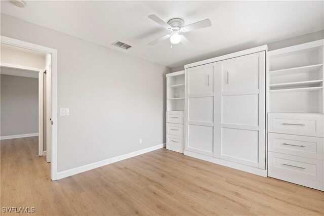 unfurnished bedroom with light wood finished floors, a closet, visible vents, and baseboards