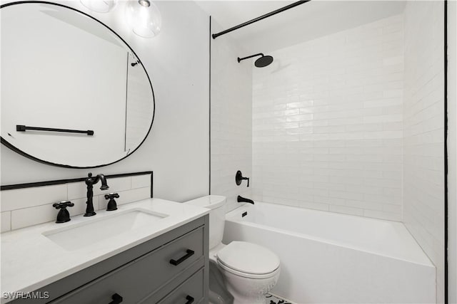 bathroom featuring  shower combination, backsplash, vanity, and toilet