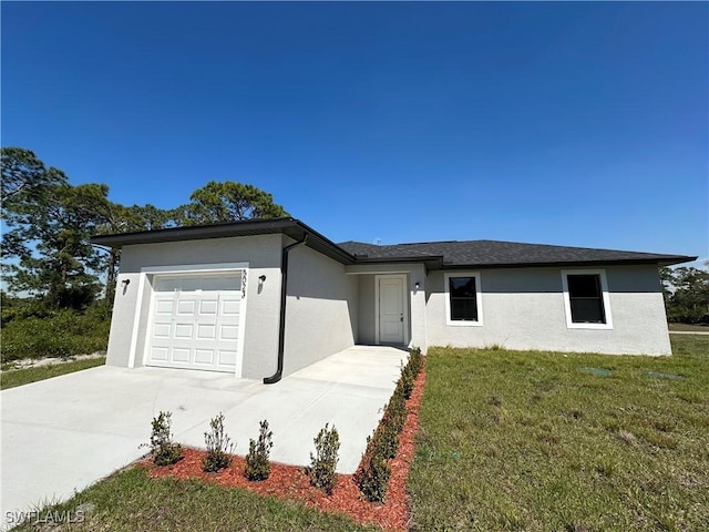 single story home featuring a front yard, an attached garage, driveway, and stucco siding