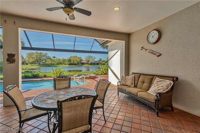 interior space with ceiling fan, a water view, and a healthy amount of sunlight