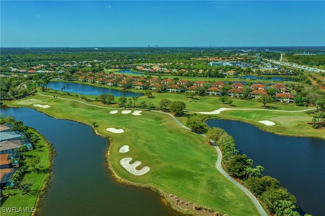 birds eye view of property featuring golf course view and a water view