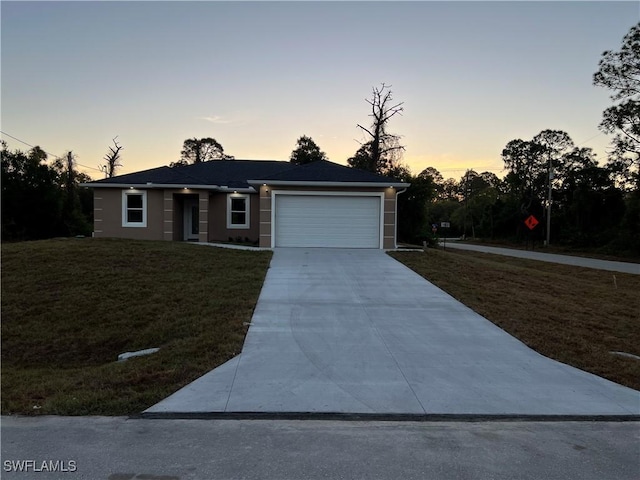 single story home featuring concrete driveway, an attached garage, a front lawn, and stucco siding