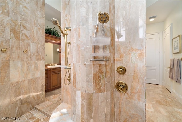 bathroom with vanity and a tile shower