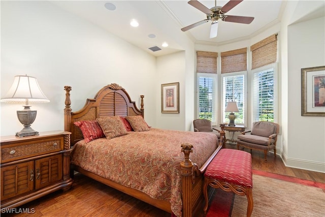 bedroom featuring visible vents, crown molding, and wood finished floors