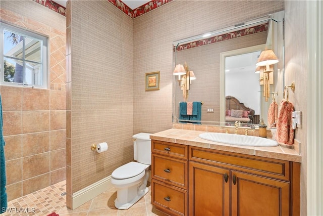 full bathroom with connected bathroom, toilet, a tile shower, tile patterned floors, and vanity