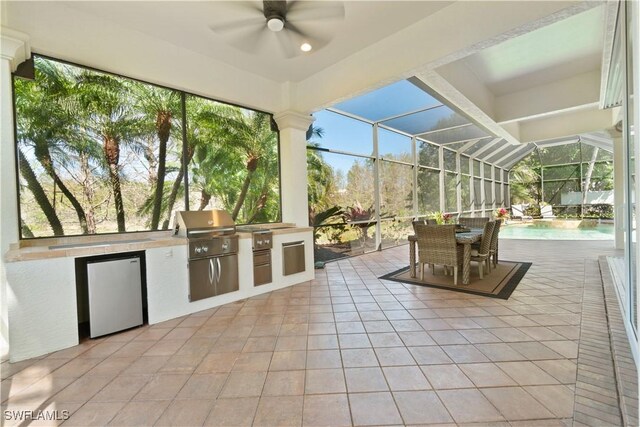 unfurnished sunroom featuring a ceiling fan and a healthy amount of sunlight