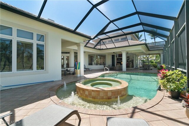 view of pool featuring a pool with connected hot tub, a patio area, and french doors