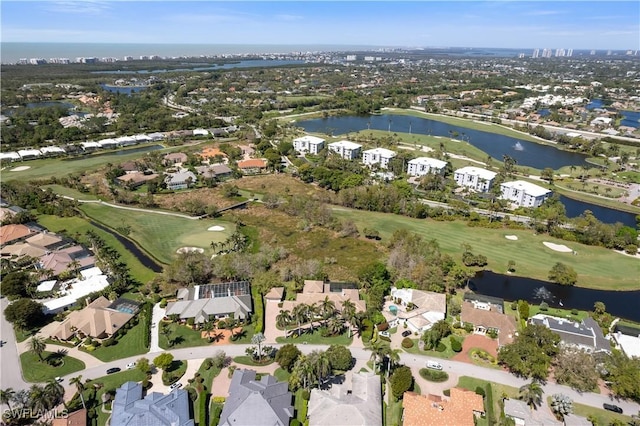 aerial view with view of golf course, a water view, and a residential view