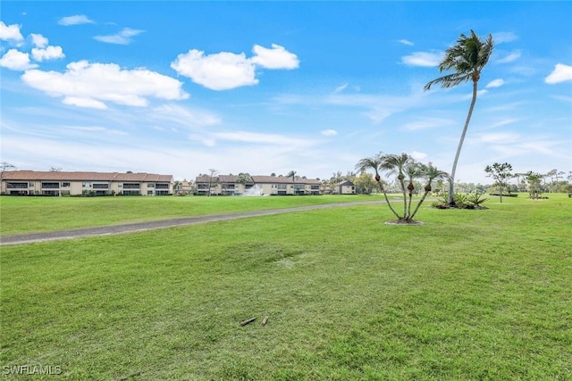 view of property's community featuring a yard