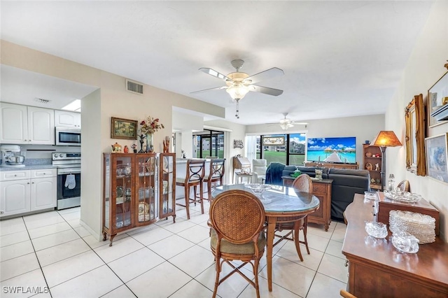 dining area featuring light tile patterned floors, ceiling fan, and visible vents