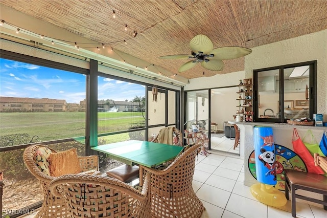 sunroom with a ceiling fan