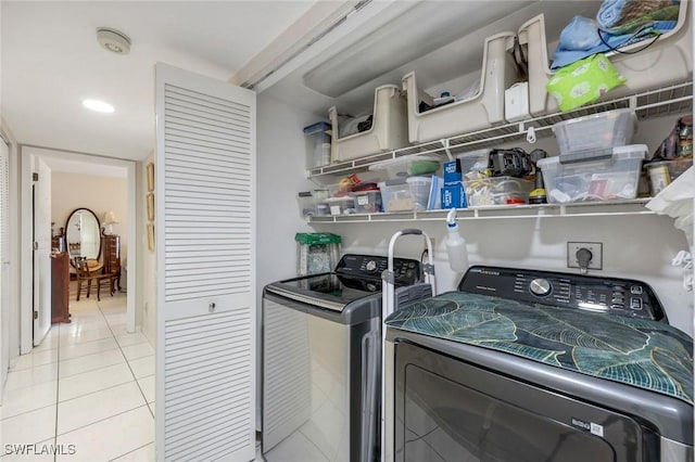 clothes washing area featuring light tile patterned floors, laundry area, independent washer and dryer, and recessed lighting