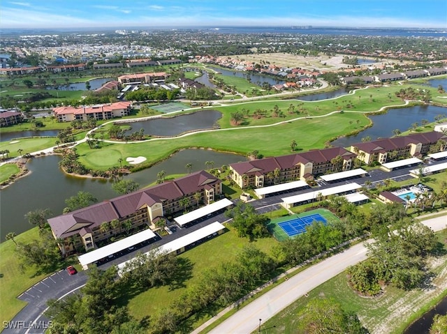 bird's eye view with view of golf course, a water view, and a residential view