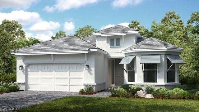 view of front of house with a garage, decorative driveway, and stucco siding