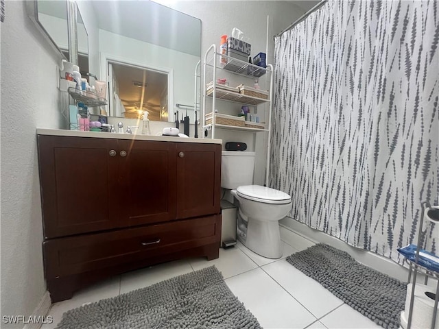 bathroom with tile patterned flooring, curtained shower, toilet, and vanity