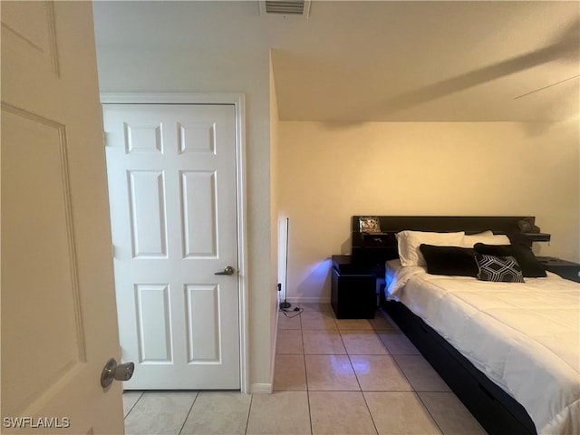 bedroom featuring visible vents, baseboards, and light tile patterned flooring