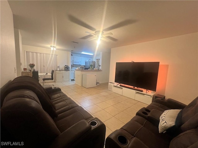 living room featuring light tile patterned floors, visible vents, and ceiling fan