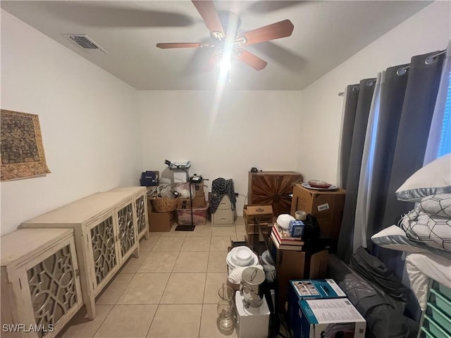 interior space with tile patterned floors, visible vents, and a ceiling fan