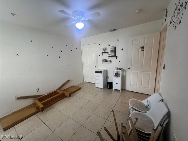 interior space with light tile patterned floors, visible vents, and ceiling fan