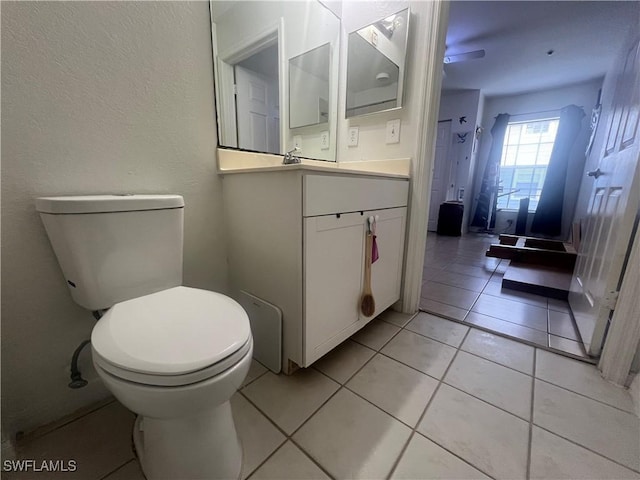 bathroom with vanity, tile patterned floors, and toilet