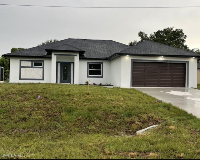 view of front of house featuring a shingled roof, concrete driveway, an attached garage, a front yard, and stucco siding