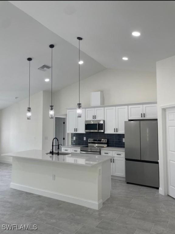 kitchen with white cabinets, decorative backsplash, stainless steel appliances, high vaulted ceiling, and a sink