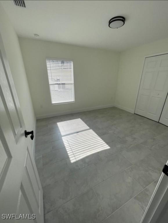 unfurnished bedroom with baseboards