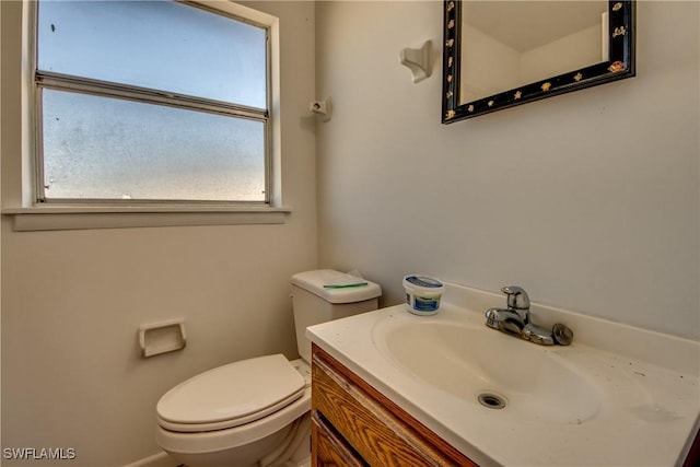 half bath featuring toilet and vanity