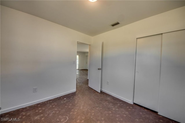 unfurnished bedroom featuring a closet, visible vents, and baseboards