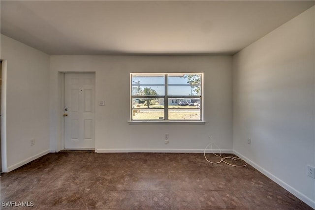 empty room featuring baseboards