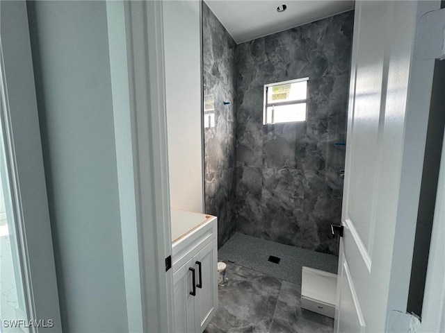 full bathroom with a stall shower and vanity