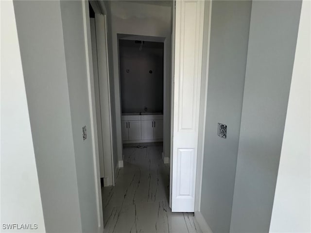 hallway with marble finish floor