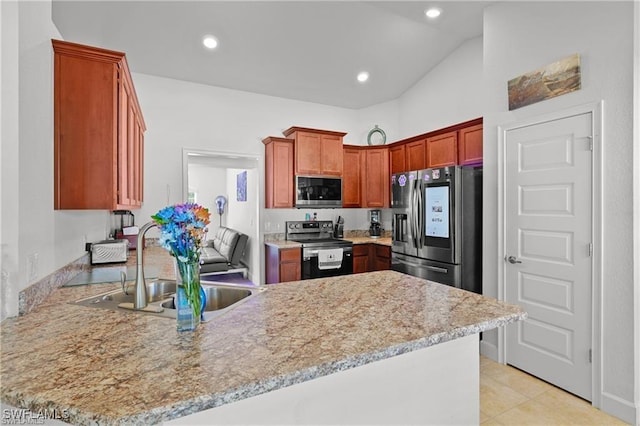 kitchen featuring lofted ceiling, recessed lighting, stainless steel appliances, a peninsula, and a sink