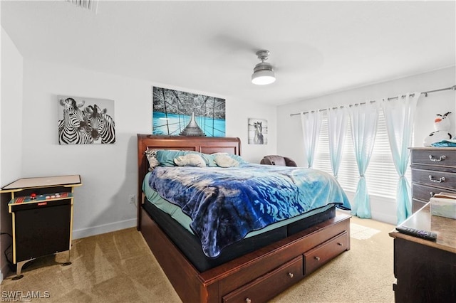 bedroom with a ceiling fan, carpet, and baseboards