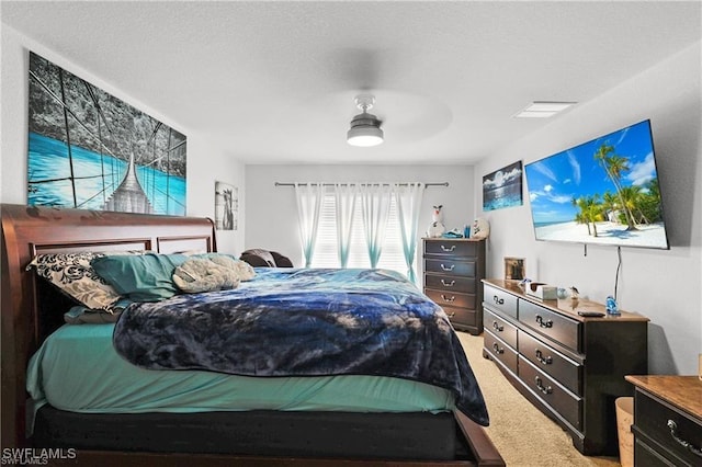 carpeted bedroom with ceiling fan and visible vents