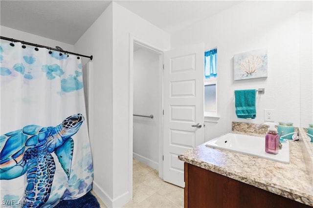 bathroom with a shower with curtain, vanity, baseboards, and tile patterned floors