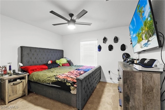 carpeted bedroom with ceiling fan and baseboards