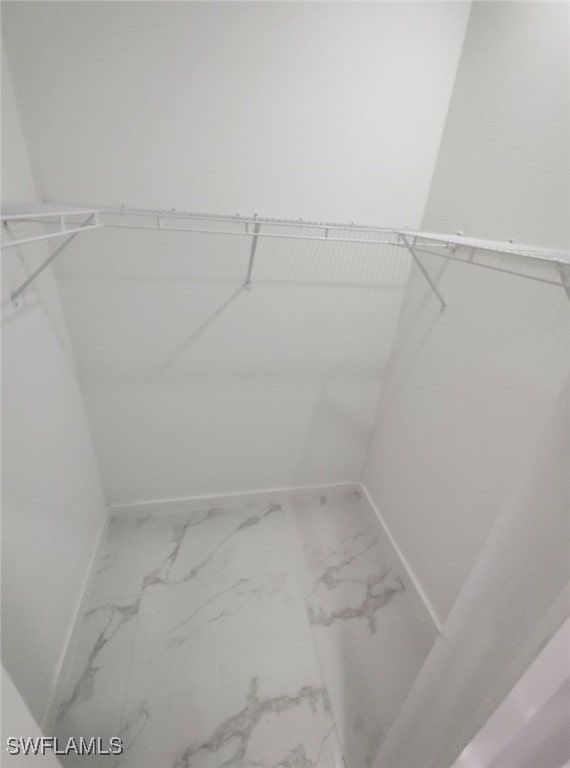 spacious closet with marble finish floor