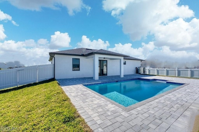 view of swimming pool featuring a lawn, a patio area, a fenced backyard, and a fenced in pool