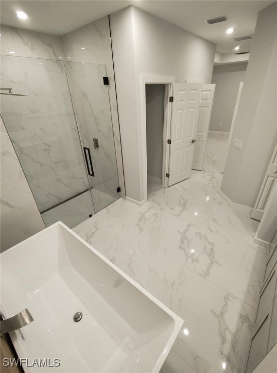 full bath featuring marble finish floor, a marble finish shower, recessed lighting, a sink, and baseboards