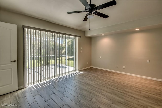 unfurnished room featuring ceiling fan, baseboards, and wood finished floors